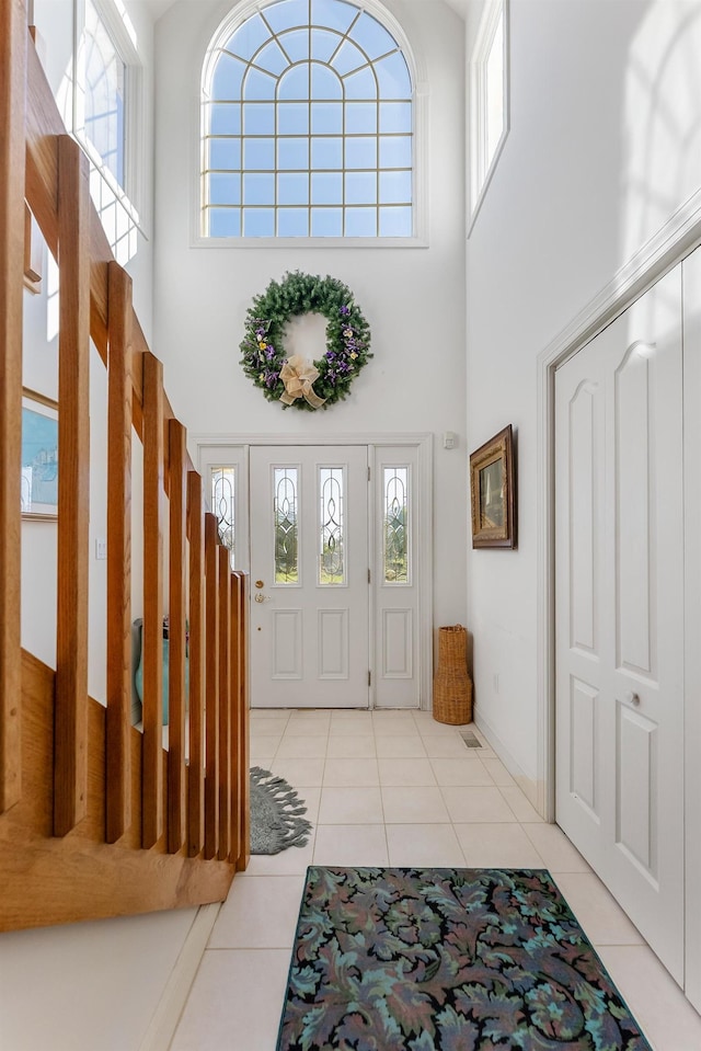 7423 Ocean Dr, Avalon, NJ 08202 - foyer entrance with a towering ceiling, light tile patterned floors, plenty of natural light, and baseboards