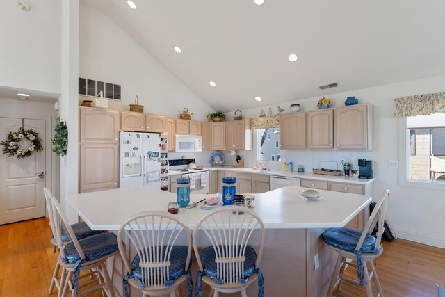 7423 Ocean Dr, Avalon, NJ 08202 - kitchen with white appliances, light brown cabinets, light countertops, a center island, and recessed lighting