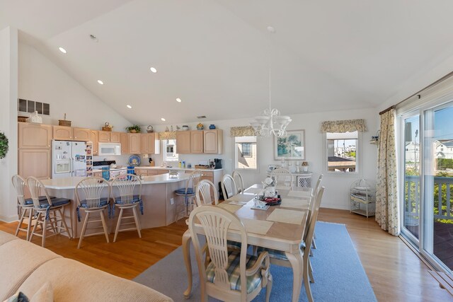 7423 Ocean Dr, Avalon, NJ 08202 - dining room featuring a chandelier, light wood-type flooring, recessed lighting, and high vaulted ceiling