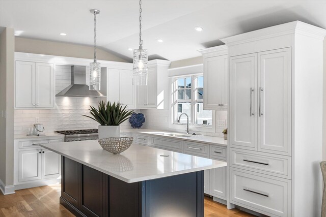 10700 3rd Ave S, Unit South, Stone Harbor, NJ 08247 - kitchen featuring a sink, wall chimney exhaust hood, white cabinetry, vaulted ceiling, and high end stainless steel range oven