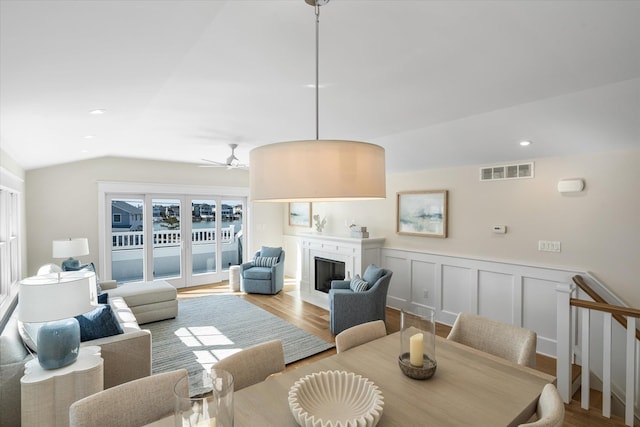 10700 3rd Ave S, Unit South, Stone Harbor, NJ 08247 - living area featuring visible vents, wainscoting, lofted ceiling, wood finished floors, and a fireplace