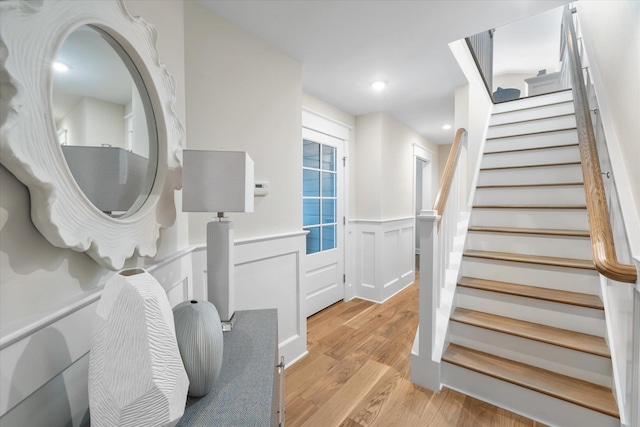 10700 3rd Ave S, Unit South, Stone Harbor, NJ 08247 - stairway featuring wood finished floors, a decorative wall, and a wainscoted wall