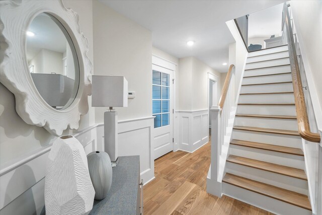 10700 3rd Ave S, Unit South, Stone Harbor, NJ 08247 - stairs featuring a decorative wall, wood finished floors, and a wainscoted wall