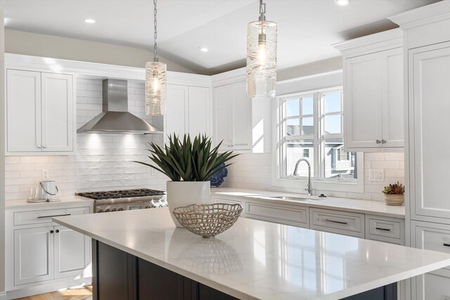 10700 3rd Ave S, Unit South, Stone Harbor, NJ 08247 - kitchen featuring a center island, tasteful backsplash, white cabinetry, a sink, and wall chimney exhaust hood