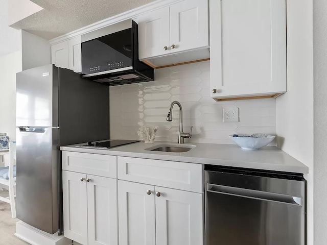 kitchen featuring white cabinets, backsplash, stainless steel dishwasher, and sink