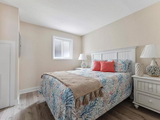 bedroom with hardwood / wood-style flooring