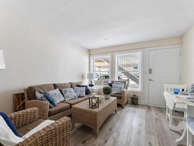 living room featuring light hardwood / wood-style floors and a textured ceiling