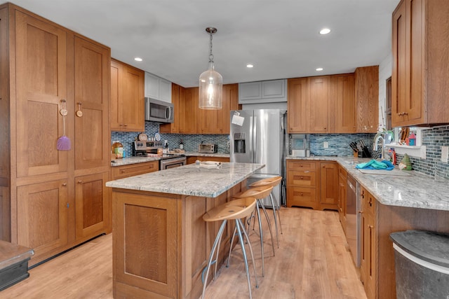 716 Dias Creek Rd, Cape May Court House, NJ 08210 - kitchen with stainless steel appliances, a sink, tasteful backsplash, light wood-style floors, and brown cabinets