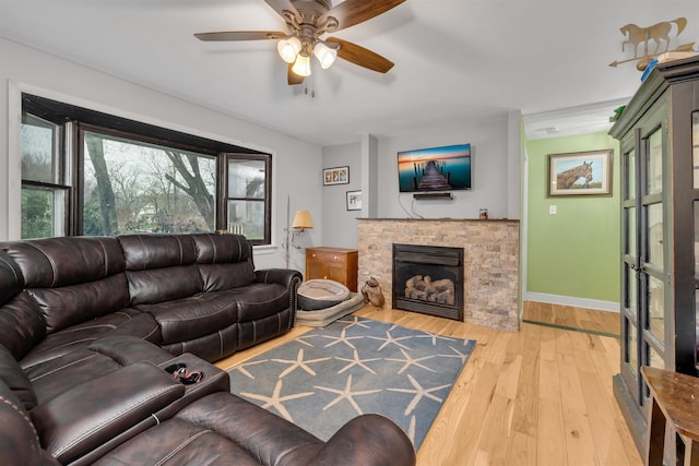 716 Dias Creek Rd, Cape May Court House, NJ 08210 - living room with hardwood / wood-style flooring, ceiling fan, a stone fireplace, and baseboards