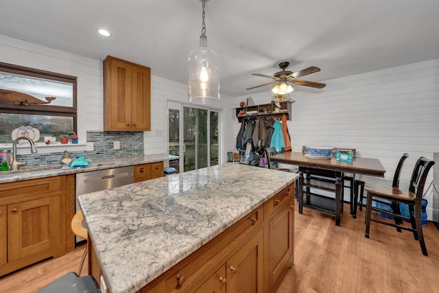 716 Dias Creek Rd, Cape May Court House, NJ 08210 - kitchen with a sink, brown cabinets, light wood finished floors, light stone counters, and wooden walls