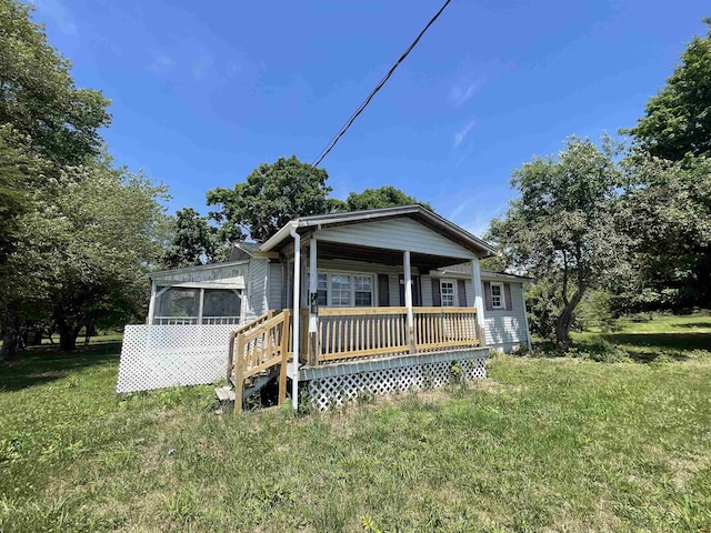 view of front of home with a sunroom and covered porch