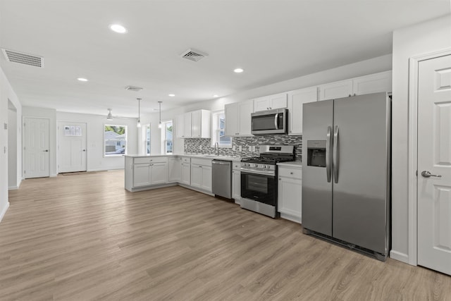 108 Sunray Beach Rd, Del Haven, NJ 08251 - kitchen featuring stainless steel appliances, a peninsula, light wood-type flooring, decorative backsplash, and recessed lighting