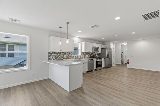 108 Sunray Beach Rd, Del Haven, NJ 08251 - kitchen with stainless steel appliances, light countertops, light wood finished floors, backsplash, and recessed lighting