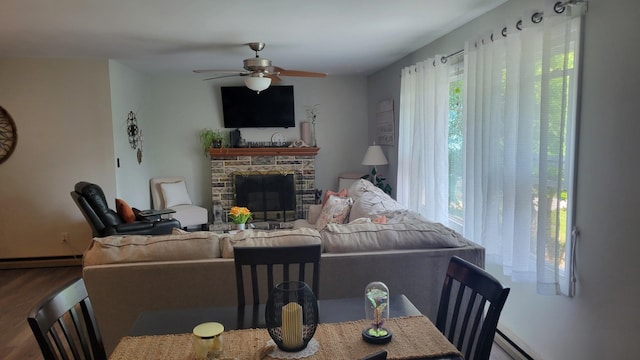 113 Heidi Ave, North Cape May, NJ 08204 - living room featuring wood finished floors, ceiling fan, a baseboard heating unit, a fireplace, and baseboards