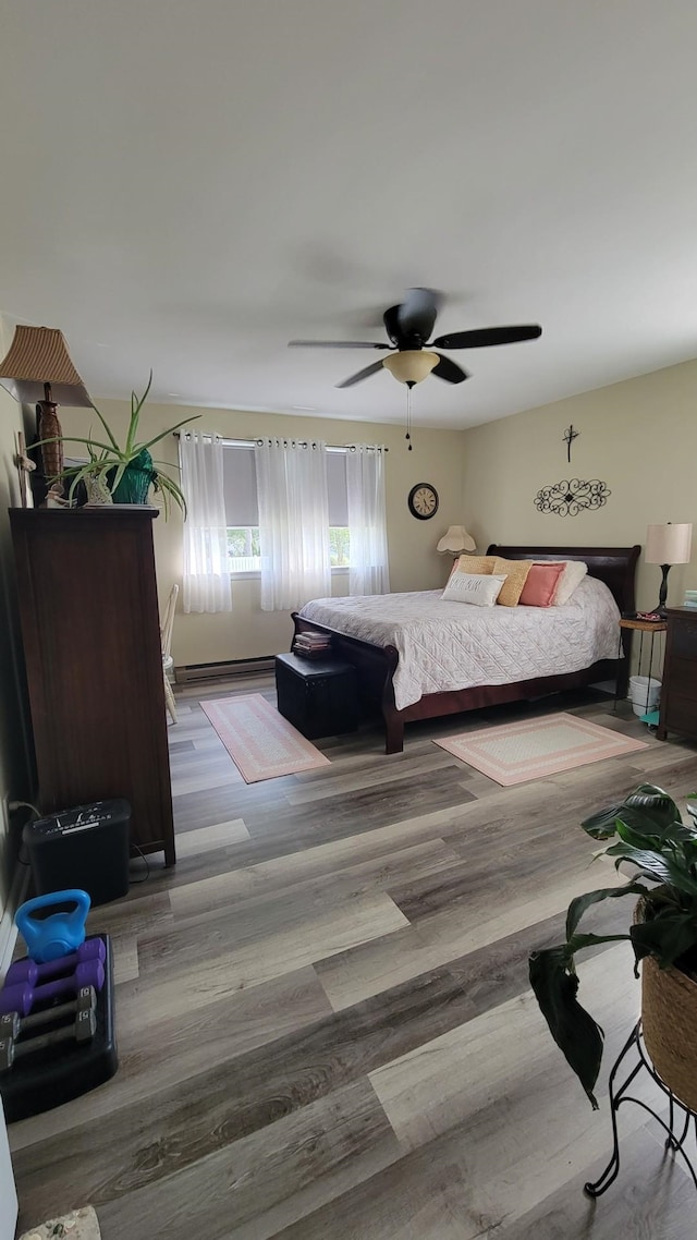 113 Heidi Ave, North Cape May, NJ 08204 - bedroom featuring wood finished floors, a ceiling fan, and baseboard heating
