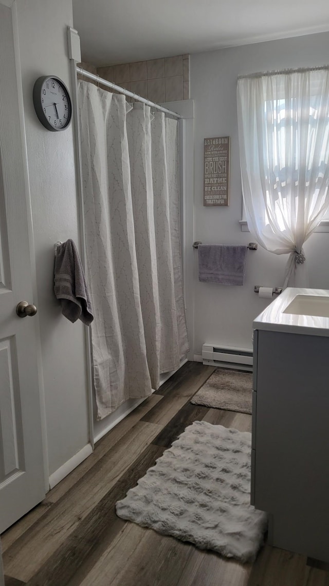 113 Heidi Ave, North Cape May, NJ 08204 - full bathroom featuring a baseboard heating unit, vanity, curtained shower, and wood finished floors
