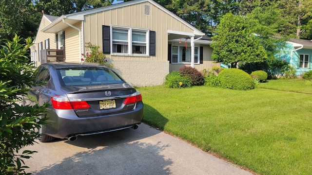113 Heidi Ave, North Cape May, NJ 08204 - view of front of property with a front yard, brick siding, and board and batten siding