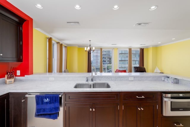 kitchen featuring sink, an inviting chandelier, kitchen peninsula, appliances with stainless steel finishes, and ornamental molding