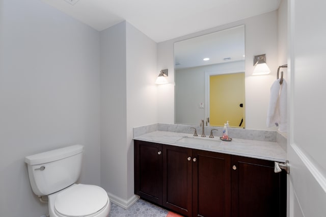 bathroom with tile patterned floors, vanity, and toilet