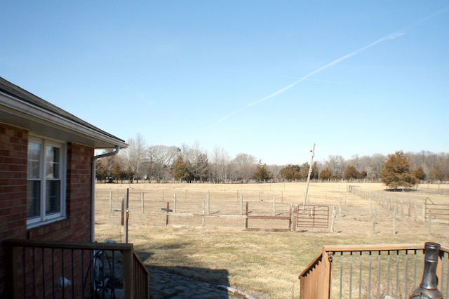 view of yard with a rural view and fence