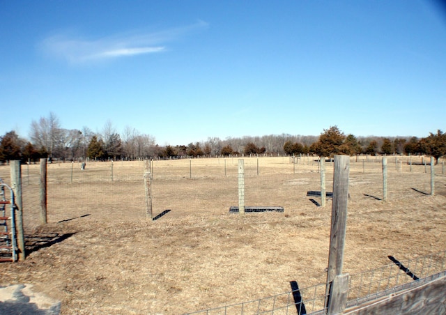 view of yard featuring fence and a rural view