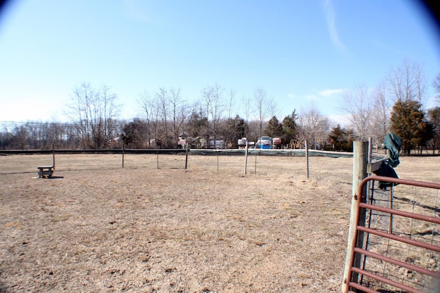 view of yard with a rural view and fence