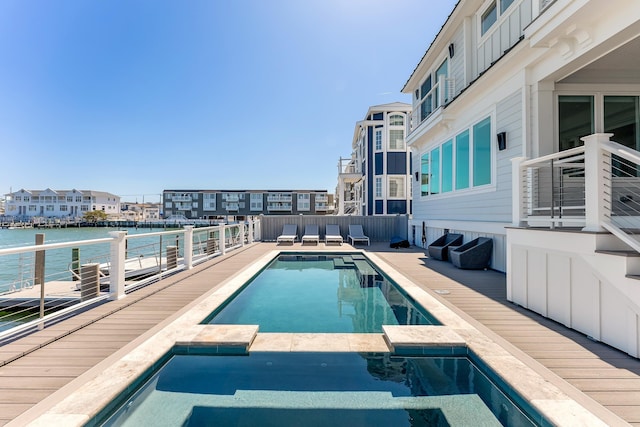 370 83rd St E, Unit East, Stone Harbor, NJ 08247 - view of swimming pool featuring a water view and a pool with connected hot tub