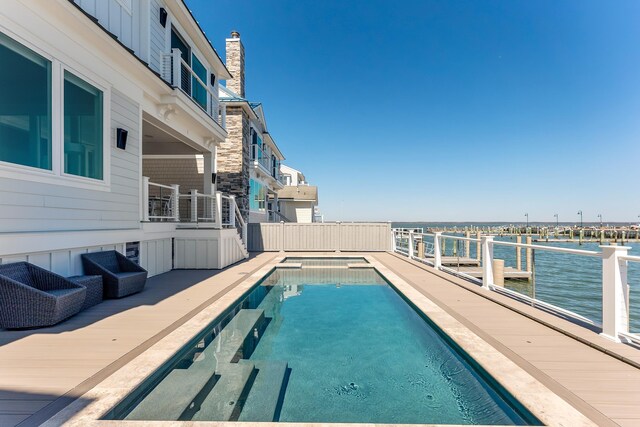 view of swimming pool featuring a water view and a fenced in pool
