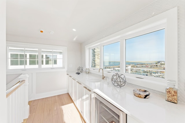 370 83rd St E, Unit East, Stone Harbor, NJ 08247 - kitchen with wine cooler, light wood finished floors, light countertops, white cabinets, and recessed lighting