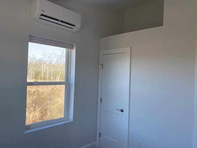 spare room with an AC wall unit