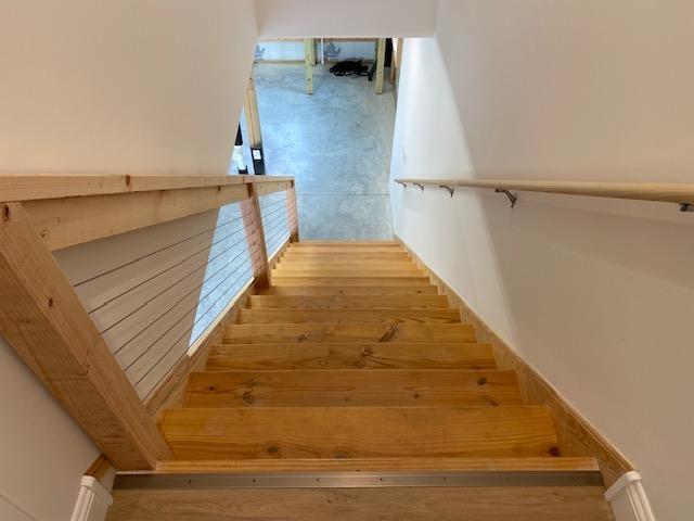 staircase with wood-type flooring