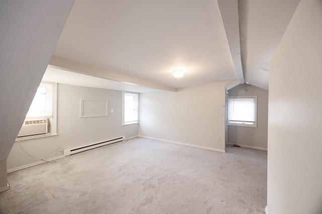 additional living space with vaulted ceiling with beams, light colored carpet, and a baseboard heating unit