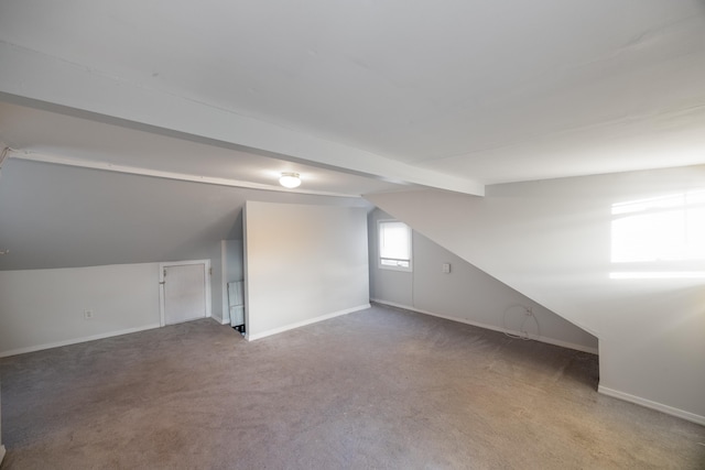 bonus room with carpet flooring and vaulted ceiling