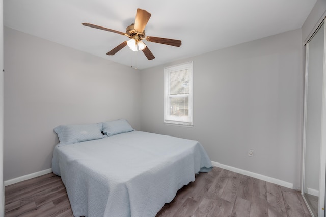 bedroom with light hardwood / wood-style floors and ceiling fan