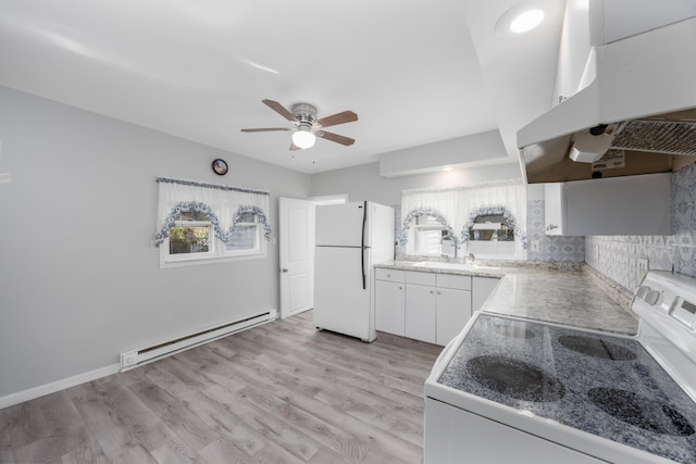 kitchen with white cabinets, white refrigerator, baseboard heating, range, and extractor fan