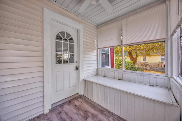 view of exterior entry featuring covered porch