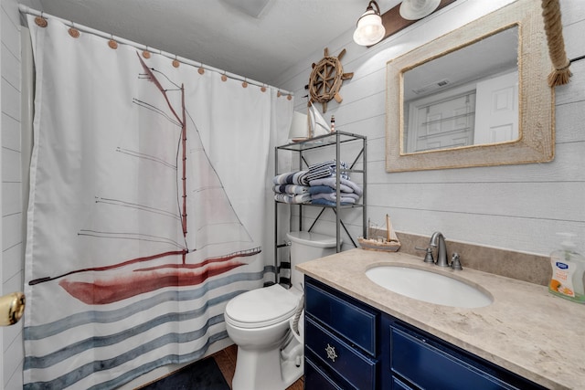301 E S Station Ave Unit 126, Lower Township, NJ 08260 - bathroom featuring a shower with shower curtain, vanity, wood walls, and toilet