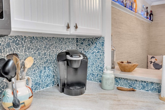301 E S Station Ave Unit 126, Lower Township, NJ 08260 - details featuring white cabinets, backsplash, and ornamental molding
