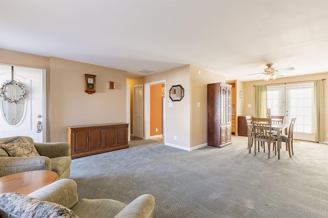 living room featuring french doors, light colored carpet, and ceiling fan