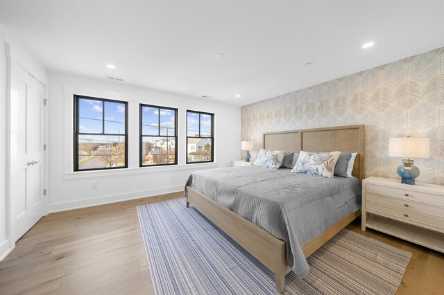 2977 Dune Dr Unit 6, Avalon, NJ 08202 - bedroom with wallpapered walls, an accent wall, baseboards, light wood-style floors, and recessed lighting