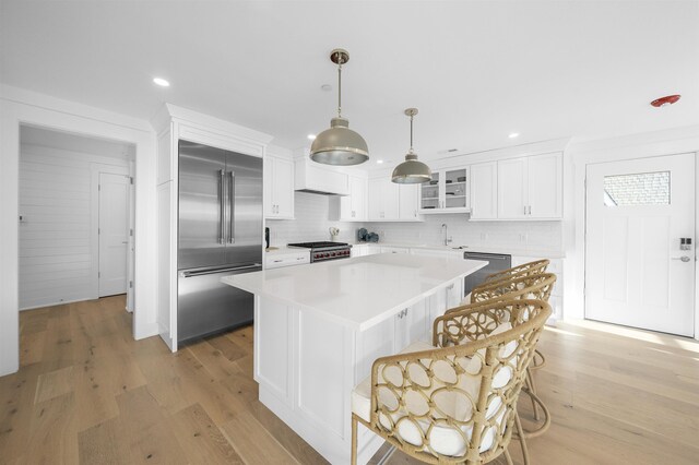 2977 Dune Dr Unit 6, Avalon, NJ 08202 - kitchen featuring appliances with stainless steel finishes, backsplash, light wood-style flooring, white cabinets, and recessed lighting