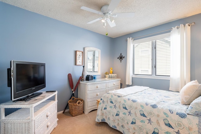 carpeted bedroom featuring a textured ceiling and ceiling fan