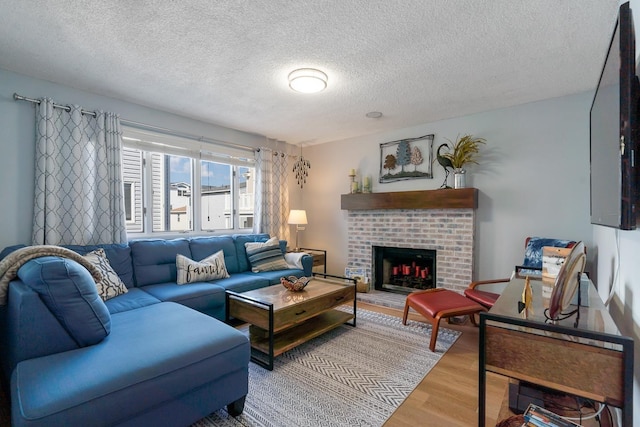 living room with a fireplace, wood-type flooring, and a textured ceiling