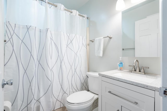 bathroom with vanity, toilet, and walk in shower