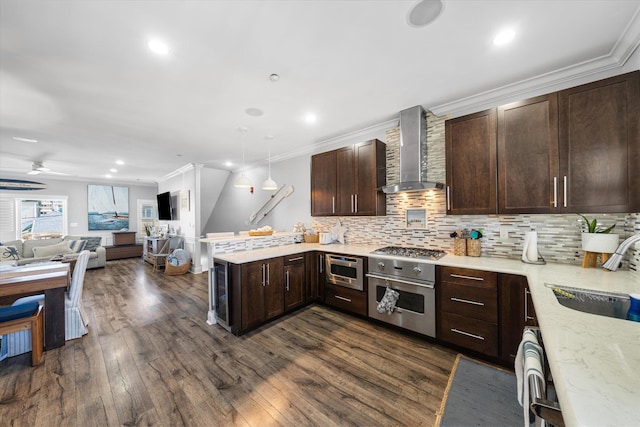110 W Walnut Ave Unit 103, North Wildwood, NJ 08260 - kitchen featuring wall chimney exhaust hood, oven, stainless steel gas cooktop, a peninsula, and open floor plan