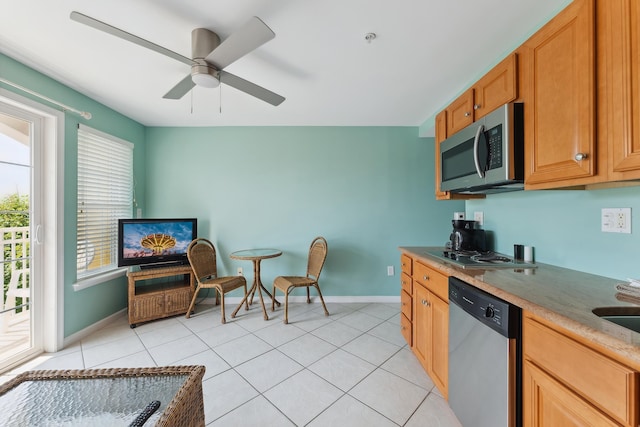 kitchen with ceiling fan, light tile patterned flooring, and stainless steel appliances