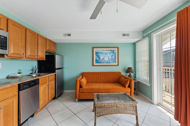 kitchen featuring ceiling fan, light tile patterned floors, sink, and appliances with stainless steel finishes