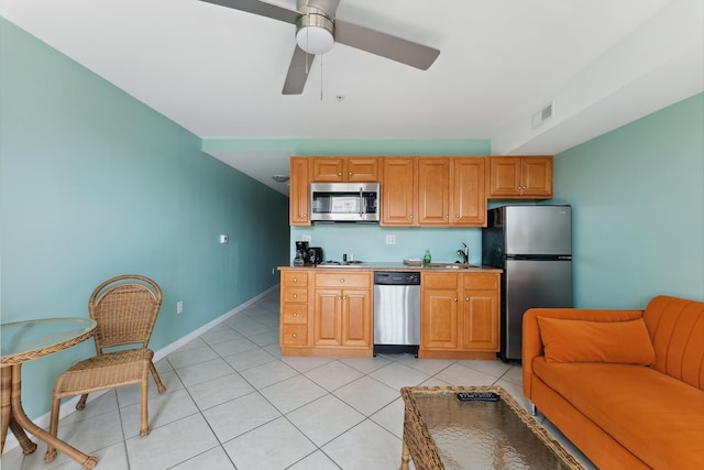 kitchen with ceiling fan, sink, light tile patterned floors, and stainless steel appliances