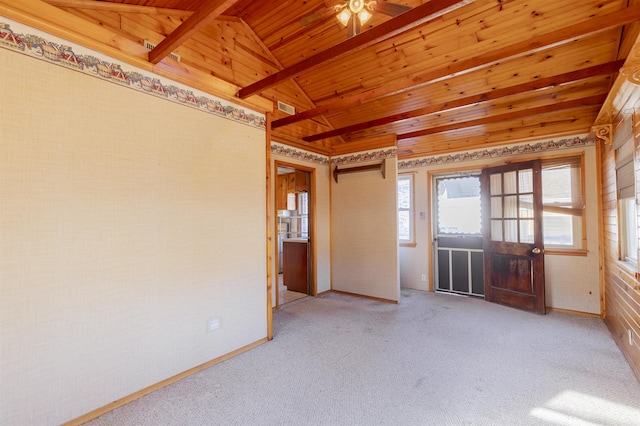 carpeted spare room with vaulted ceiling with beams and wooden ceiling