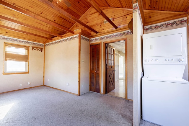 interior space with lofted ceiling, wooden ceiling, and stacked washer and clothes dryer